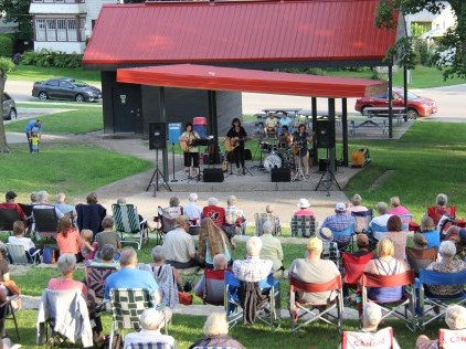 Crowd watching live music in park