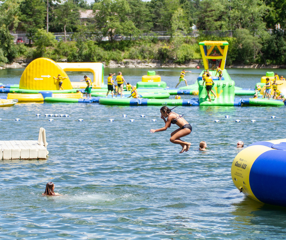 girl jumping into water off of trampoline