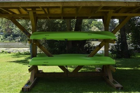 Kayaks on stand next to Thames River